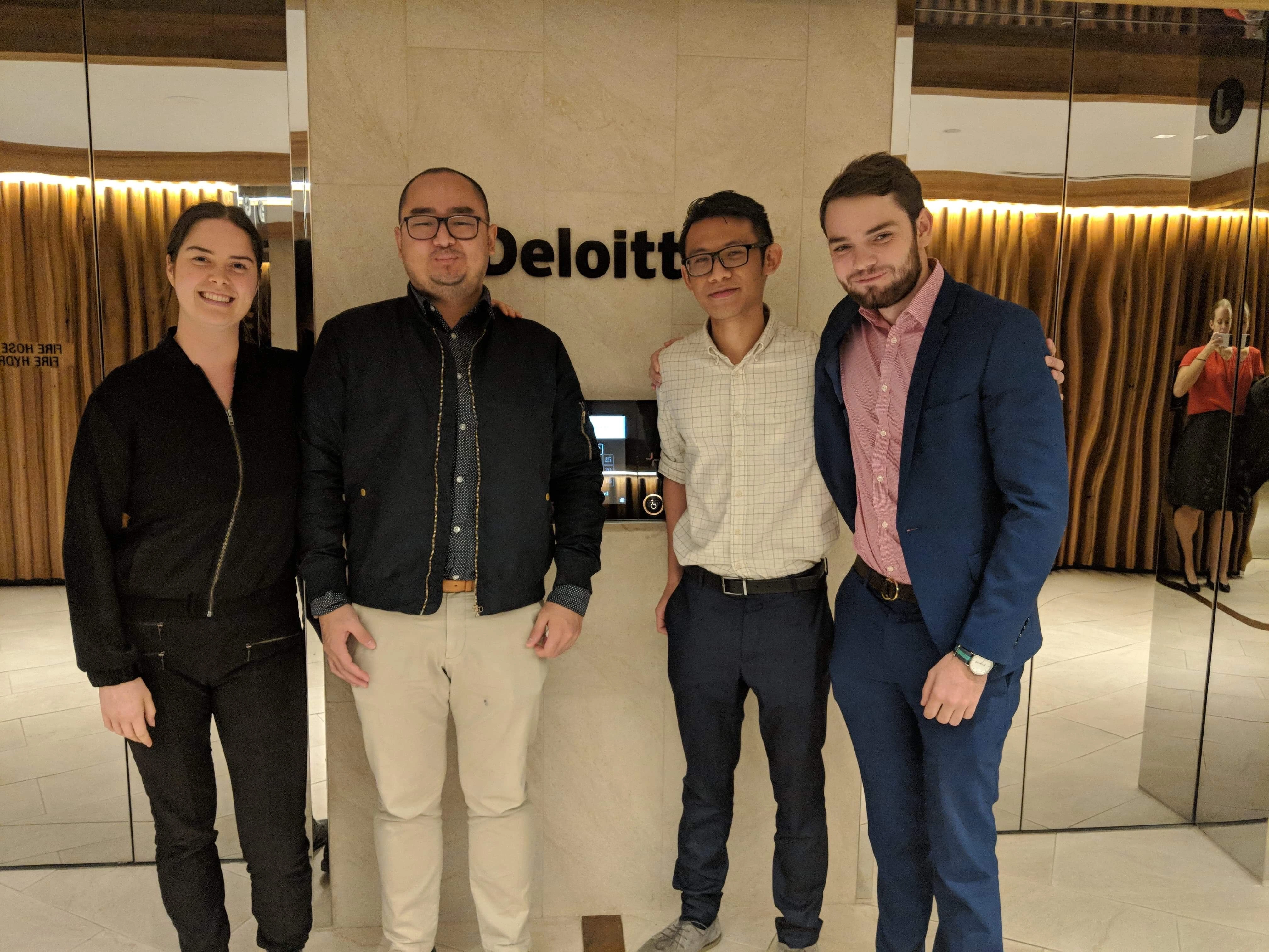 Winston and his three mentees standing at the entrance of a lift at Deloitte.